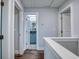 Upstairs hallway with hardwood floors, white doors, and view of bathroom with light blue vanity at 2705 Mercer Dr. # 2705, Conway, SC 29526