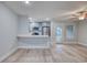 Open-concept living room with sleek breakfast bar, modern lighting, and wood-look tile at 2705 Mercer Dr. # 2705, Conway, SC 29526
