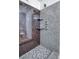 Luxurious shower with granite-look walls, shelves, mosaic tile flooring, and glass doors at 2705 Mercer Dr. # 2705, Conway, SC 29526