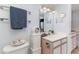 Bathroom featuring a vanity with decorative items, toilet, and wall mirror at 2710 S Ocean Blvd. # 1010, North Myrtle Beach, SC 29582