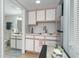 Kitchenette with white cabinets, stainless steel refrigerator, and adjacent bathroom at 2710 S Ocean Blvd. # 1010, North Myrtle Beach, SC 29582