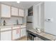 Kitchenette with white cabinets, stainless steel refrigerator, and breakfast table at 2710 S Ocean Blvd. # 1010, North Myrtle Beach, SC 29582