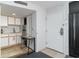 Kitchenette features white cabinets, stainless steel refrigerator, and breakfast table at 2710 S Ocean Blvd. # 1010, North Myrtle Beach, SC 29582