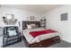 Bright bedroom with a large dark wood bed, cozy recliner and seahorse wall decor at 2710 S Ocean Blvd. # 1010, North Myrtle Beach, SC 29582