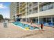 Enjoy the outdoor pool and lounge area at this stunning resort-style condominium complex with beautiful landscaping at 2710 S Ocean Blvd. # 1010, North Myrtle Beach, SC 29582