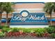 Bay Watch Resort & Conference Center sign surrounded by colorful plants and greenery at 2710 S Ocean Blvd. # 1010, North Myrtle Beach, SC 29582