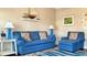 Comfortable living room with a blue sofa, floral pillows, and nautical decor, creating a beachy feel at 337 Sailors Ct., Myrtle Beach, SC 29577