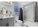 Bright bathroom featuring a tiled shower, vanity with sink, and modern fixtures at 403 Sean River Rd., Conway, SC 29526