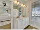 Bathroom featuring a double vanity, marble countertops and great lighting at 417 Seabreeze Dr., Garden City Beach, SC 29576