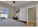 Cozy bedroom featuring a wooden sleigh bed, a window with blinds, and a mounted television at 417 Seabreeze Dr., Garden City Beach, SC 29576