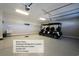 Large two-car garage featuring epoxy flooring, golf cart, central vacuum system, and a garage sink at 417 Seabreeze Dr., Garden City Beach, SC 29576