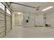 Spacious garage with epoxy flooring, a sink, refrigerator, and room for storage, all well-lit at 417 Seabreeze Dr., Garden City Beach, SC 29576