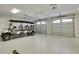 Large two-car garage featuring epoxy flooring and a golf cart, offering ample space at 417 Seabreeze Dr., Garden City Beach, SC 29576