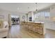 Bright kitchen featuring a large island, white cabinets, stainless steel appliances, and access to the deck at 417 Seabreeze Dr., Garden City Beach, SC 29576