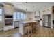 Bright, open kitchen featuring white cabinetry, stainless steel appliances, and a large island with counter seating at 417 Seabreeze Dr., Garden City Beach, SC 29576