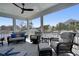 Spacious screened porch featuring comfortable seating and a view of the peaceful surroundings at 417 Seabreeze Dr., Garden City Beach, SC 29576