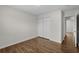 Bedroom with wood-look flooring, closet, and doorway to next room at 4355 Heartwood Ln., Myrtle Beach, SC 29579