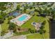Aerial view of a pool and playground area featuring ample green space and mature trees at 4355 Heartwood Ln., Myrtle Beach, SC 29579