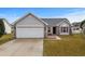 Charming single-story home features an attached two-car garage and well-manicured lawn at 4355 Heartwood Ln., Myrtle Beach, SC 29579
