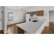 Bright kitchen features a breakfast bar, white appliances, wood cabinets and flooring at 4355 Heartwood Ln., Myrtle Beach, SC 29579