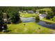 Beautiful aerial view of a golf course, ponds, and clubhouse surrounded by trees at 4430 Eastport Blvd. # L9, Little River, SC 29566