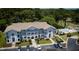 Aerial view showcasing the condo building, parking area, pool, and surrounding greenery at 4430 Eastport Blvd. # L9, Little River, SC 29566