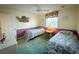 Inviting bedroom featuring two twin beds, soft green carpet, and a decorative seashell accent at 4430 Eastport Blvd. # L9, Little River, SC 29566