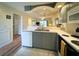 Well-lit kitchen with stainless steel sink, ample countertop space, and tiled flooring at 4430 Eastport Blvd. # L9, Little River, SC 29566