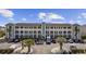 Wide shot of the building featuring a parking lot, balconies, and palm trees at 4520 N Plantation Harbour Dr. # F9, Little River, SC 29566