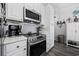 Kitchen featuring stainless steel appliances, white cabinets, and gray subway tile backsplash at 4520 N Plantation Harbour Dr. # F9, Little River, SC 29566