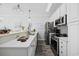 Kitchen with white countertops, stainless steel appliances, breakfast bar, and a gray backsplash at 4520 N Plantation Harbour Dr. # F9, Little River, SC 29566
