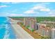 Scenic view of beachfront condos, ocean, and coastline under a partly cloudy sky at 4719 S Ocean Blvd. # Ph5, North Myrtle Beach, SC 29582