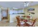 Cozy condo kitchen featuring white cabinetry, tile flooring and glass table at 4719 S Ocean Blvd. # Ph5, North Myrtle Beach, SC 29582