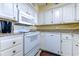 Well-lit kitchen featuring white cabinetry, granite countertops, and modern appliances at 4719 S Ocean Blvd. # Ph5, North Myrtle Beach, SC 29582