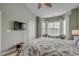 Large main bedroom with ceiling fan, carpet, and large window providing a great view of the neighborhood at 4865 Luster Leaf Circle # 402, Myrtle Beach, SC 29577