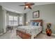 Calm main bedroom with vaulted ceiling, neutral paint, a ceiling fan, and large windows with natural light at 4865 Luster Leaf Circle # 402, Myrtle Beach, SC 29577