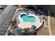 Aerial view of the pool area featuring ample lounge chairs, palm trees and manicured grounds at 4865 Luster Leaf Circle # 402, Myrtle Beach, SC 29577