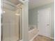 Bathroom featuring a glass-enclosed shower and separate soaking tub at 505 Hay Hill Ln. # B, Myrtle Beach, SC 29579