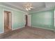 Spacious carpeted bedroom featuring a trey ceiling, ceiling fan, and multiple entry doors at 505 Hay Hill Ln. # B, Myrtle Beach, SC 29579