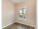 Neutral bedroom featuring a window, hardwood flooring, and light peach walls at 505 Hay Hill Ln. # B, Myrtle Beach, SC 29579