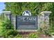 Stone monument sign for 'The Farm at Carolina Forest, a D.R. Horton Community', surrounded by greenery at 505 Hay Hill Ln. # B, Myrtle Beach, SC 29579