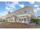 A brick and vinyl townhouse exterior with many windows and an attached patio on a sunny day at 505 Hay Hill Ln. # B, Myrtle Beach, SC 29579