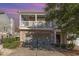 Two story home featuring a balcony, attached garage, brick facade, manicured bushes and a paved drive way at 505 Hay Hill Ln. # B, Myrtle Beach, SC 29579