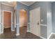 Front foyer with grey walls, trim detail, tile floors, and an arched entry to the living spaces at 505 Hay Hill Ln. # B, Myrtle Beach, SC 29579