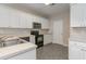 Bright kitchen featuring white cabinets, granite countertops, stainless appliances, and a modern design at 505 Hay Hill Ln. # B, Myrtle Beach, SC 29579