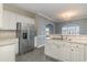 A kitchen with stainless steel appliances, white cabinets, and a view into the dining area with hardwood floors at 505 Hay Hill Ln. # B, Myrtle Beach, SC 29579