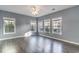 Spacious living room featuring three large windows, laminate floors and neutral walls at 505 Hay Hill Ln. # B, Myrtle Beach, SC 29579