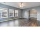 Spacious living room featuring multiple windows allowing natural light and hard wood floors at 505 Hay Hill Ln. # B, Myrtle Beach, SC 29579