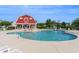 Community pool area featuring clear blue water, a red barn-style building, and plenty of seating for residents at 505 Hay Hill Ln. # B, Myrtle Beach, SC 29579