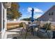 Outdoor patio with table and chairs, and a manicured backyard enclosed by a white picket fence at 509 Hillsborough Dr., Conway, SC 29526